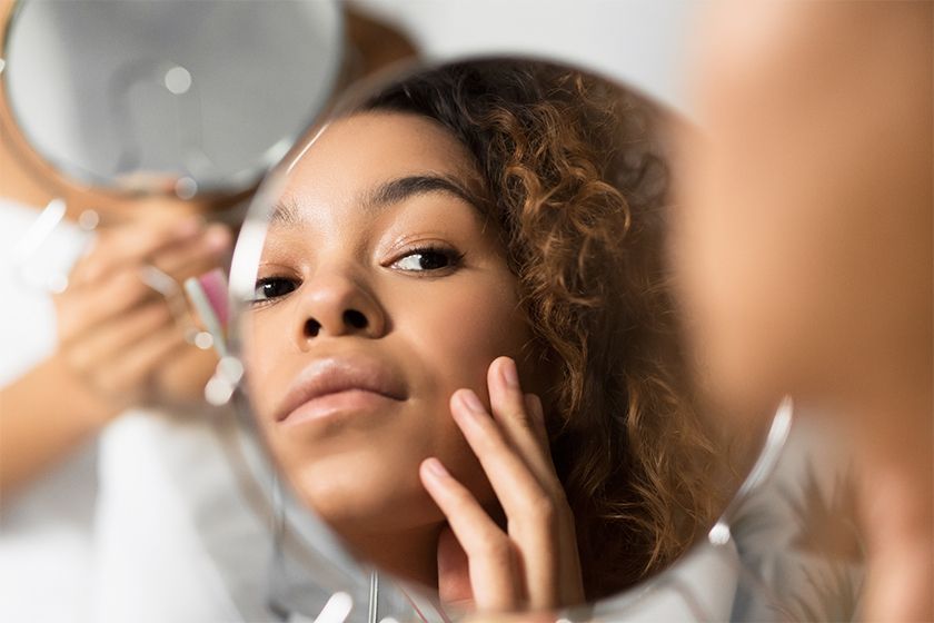 woman examining the skin