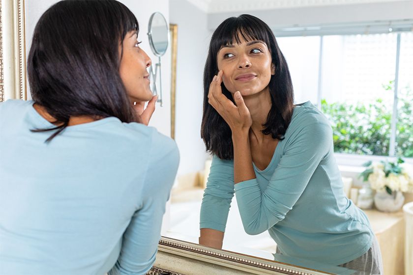 Face Massage girl looking at mirror