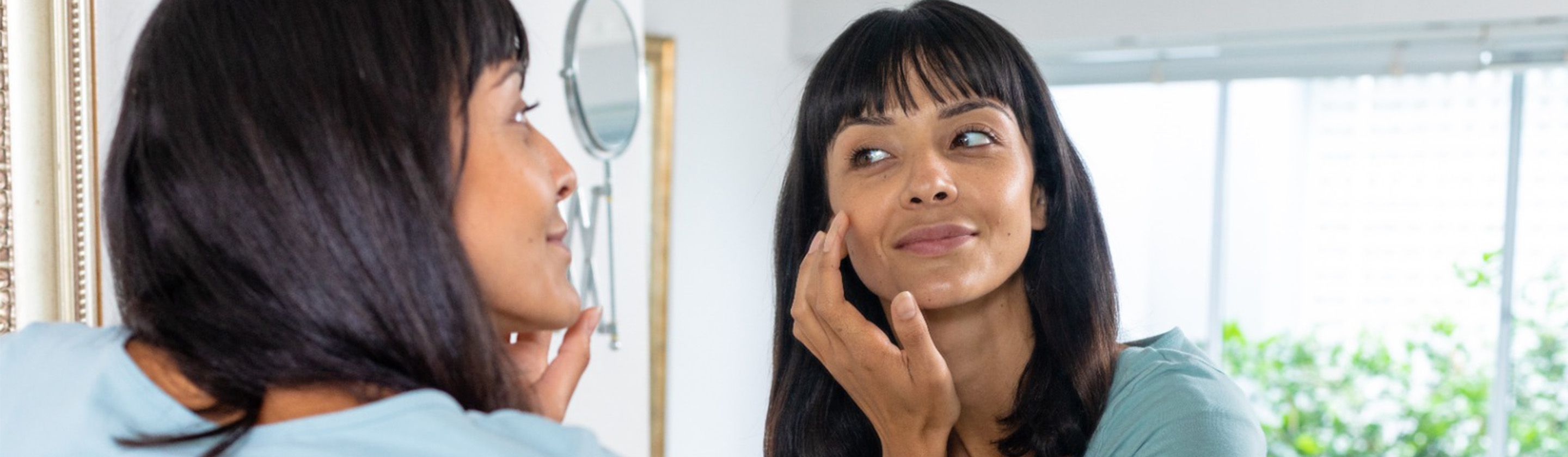 A girl looking in mirror flat