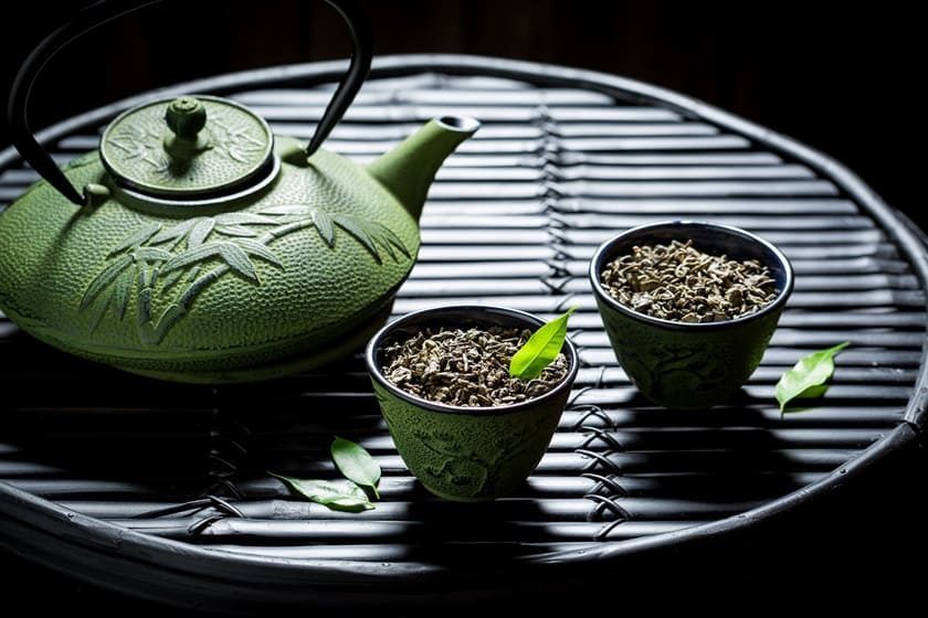 enjoy your herbal tea with teapot on black table