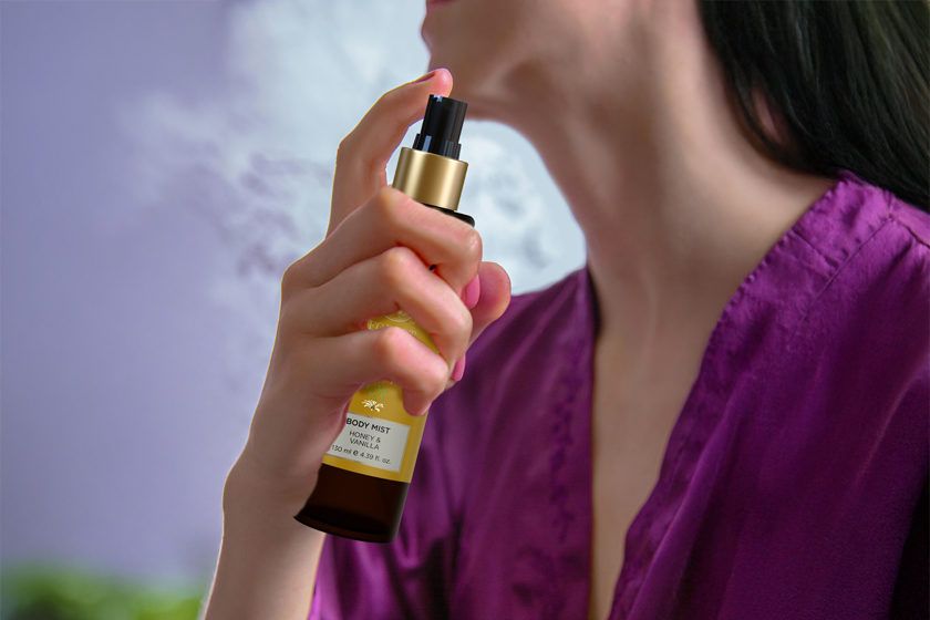 5 Things to Know About Body Mist: What It Is & How to Use It 2 Person holding honey and vanilla body mist bottle